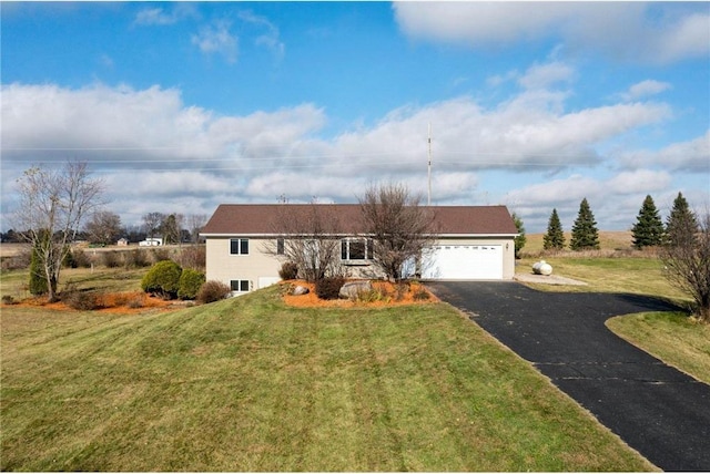 single story home featuring a front lawn and a garage