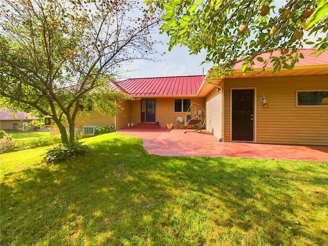 rear view of house featuring a yard and a patio area