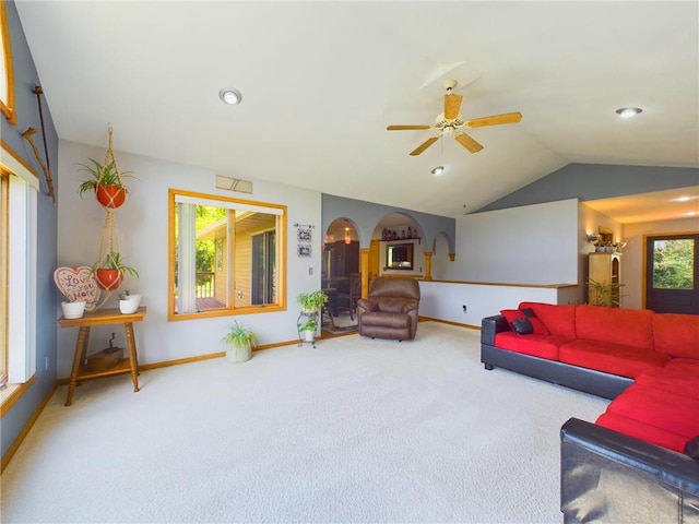 living room with lofted ceiling, ceiling fan, and carpet floors