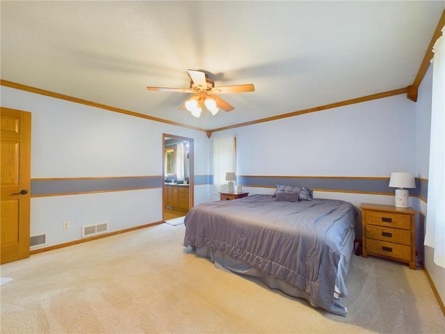 bedroom with ensuite bathroom, light colored carpet, ornamental molding, and ceiling fan