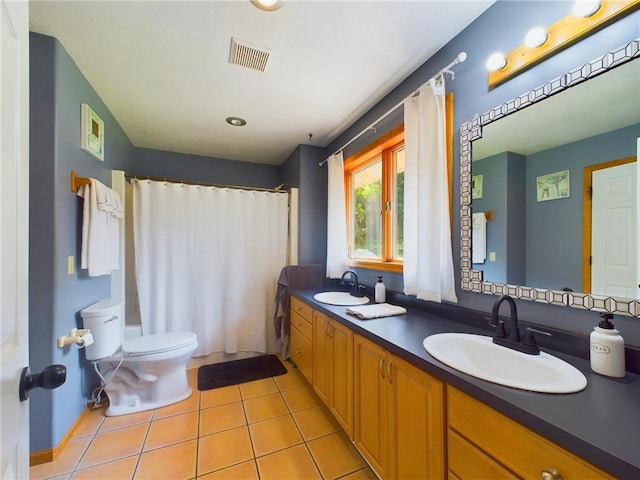 bathroom with vanity, tile patterned flooring, and toilet