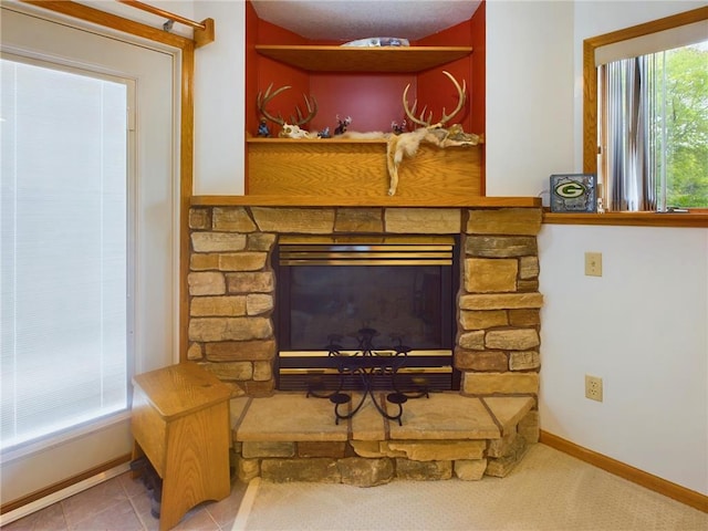 details with a stone fireplace and tile patterned flooring