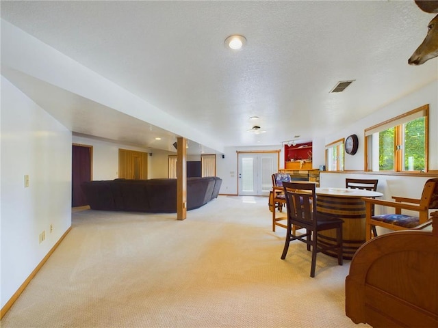 living room featuring a textured ceiling and light carpet