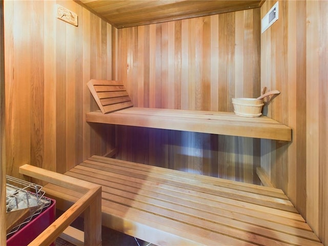 view of sauna with wood walls and wood ceiling