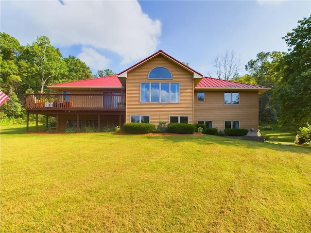 rear view of property with a lawn and a deck