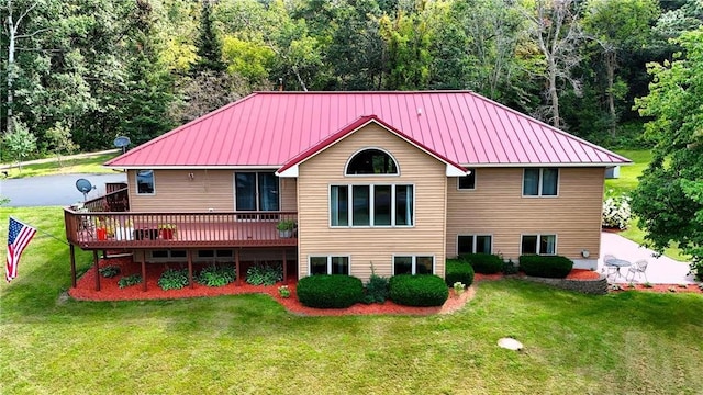 back of property featuring a yard and a wooden deck