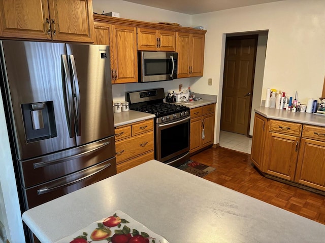 kitchen with stainless steel appliances and dark parquet floors