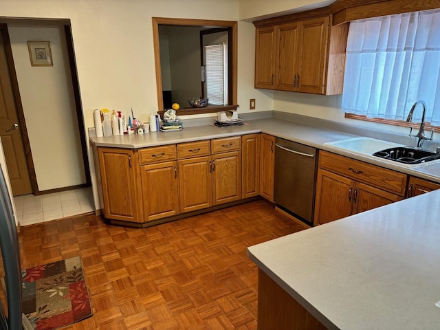 kitchen with dishwasher, a wealth of natural light, sink, and parquet flooring