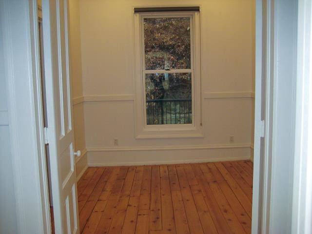 unfurnished room featuring hardwood / wood-style flooring