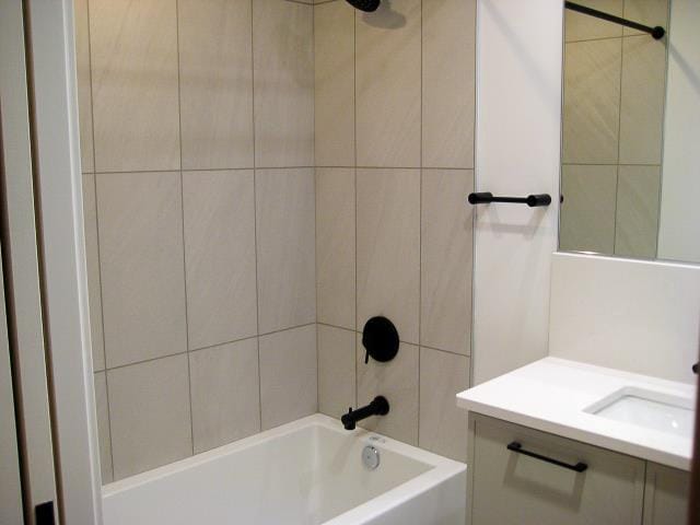 bathroom with vanity and tiled shower / bath combo