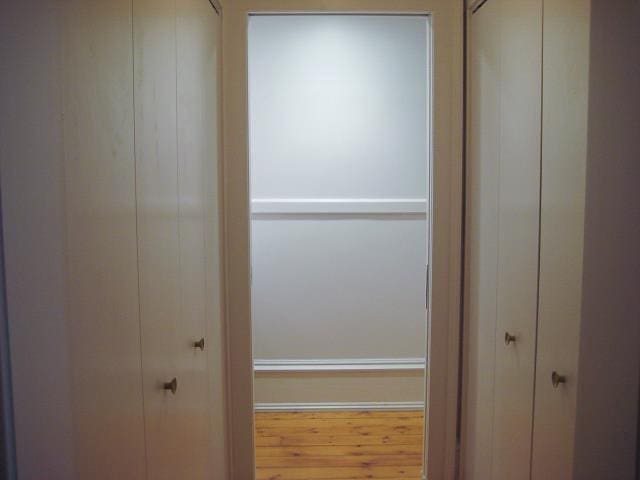 hallway with wood finished floors