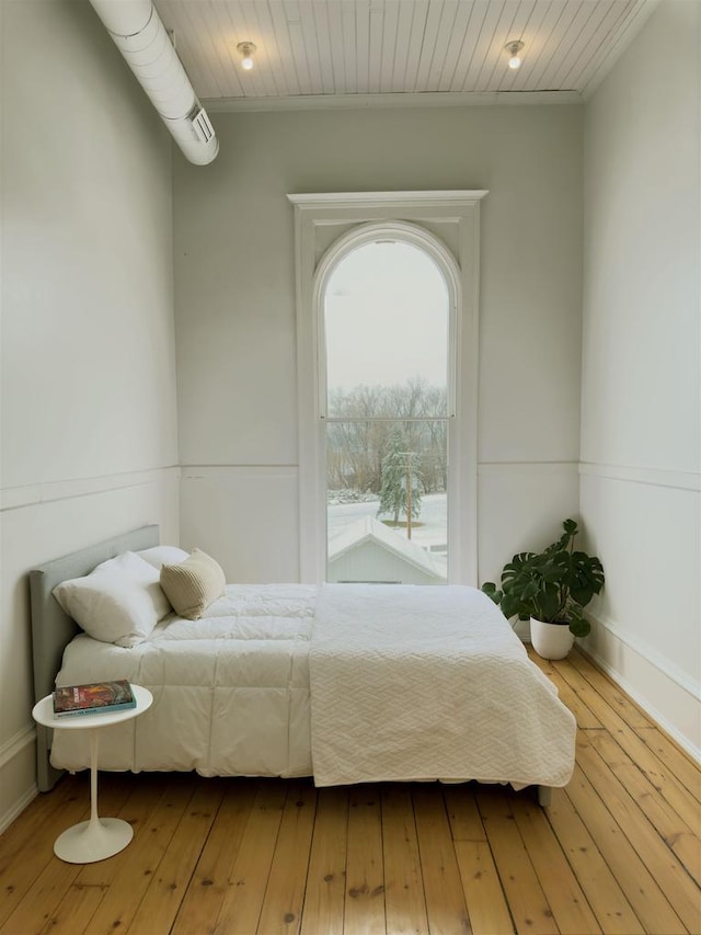 bedroom with hardwood / wood-style flooring and wooden ceiling