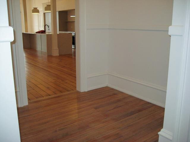 unfurnished room featuring dark hardwood / wood-style flooring and sink