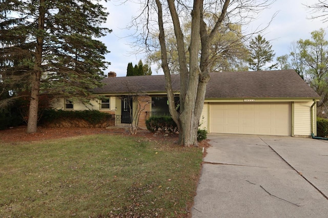 ranch-style home featuring a garage and a front lawn