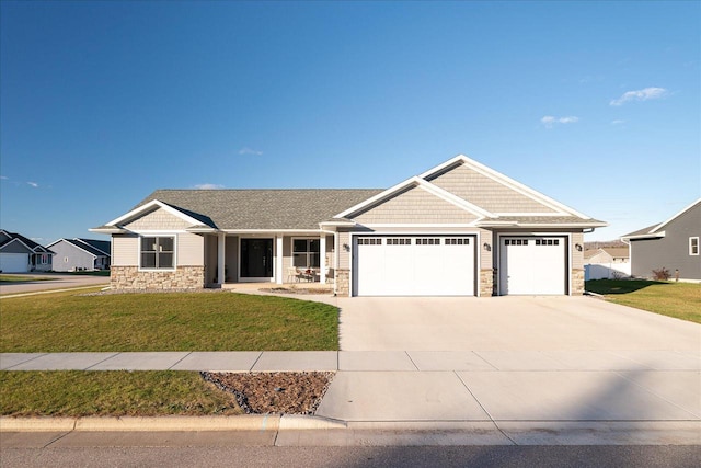 craftsman inspired home featuring a front yard and a garage