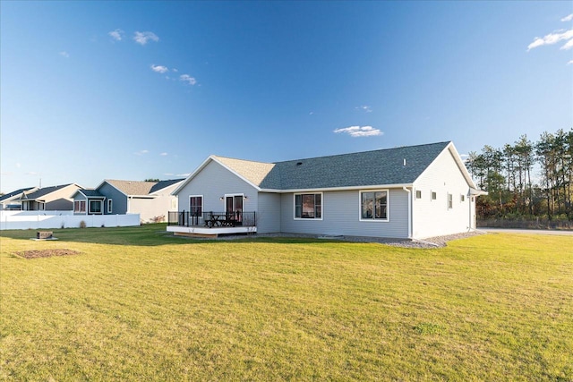 rear view of house with a yard and a deck