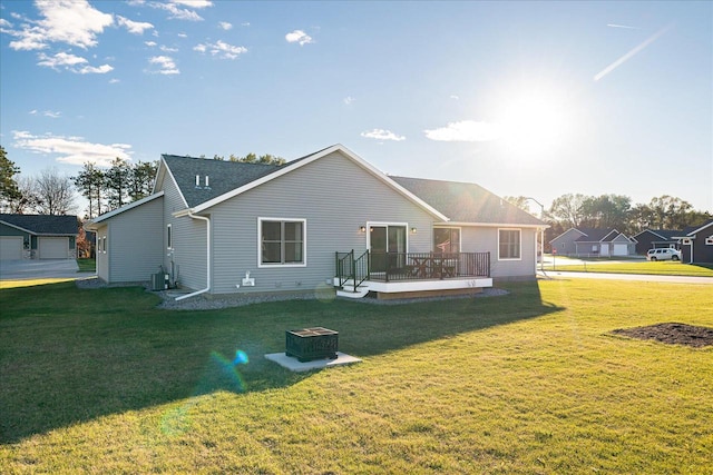 back of house with central AC unit, a wooden deck, and a yard