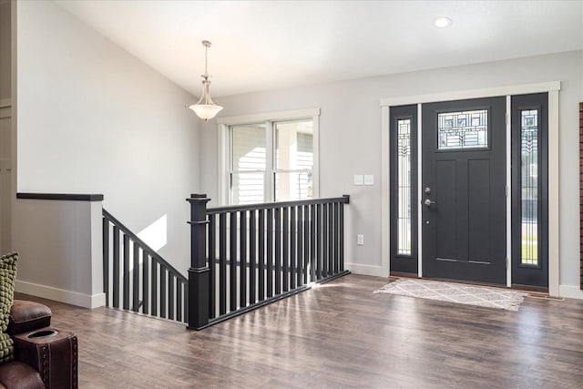 foyer entrance featuring dark hardwood / wood-style flooring and lofted ceiling