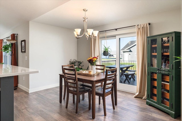 dining area featuring an inviting chandelier and dark hardwood / wood-style floors