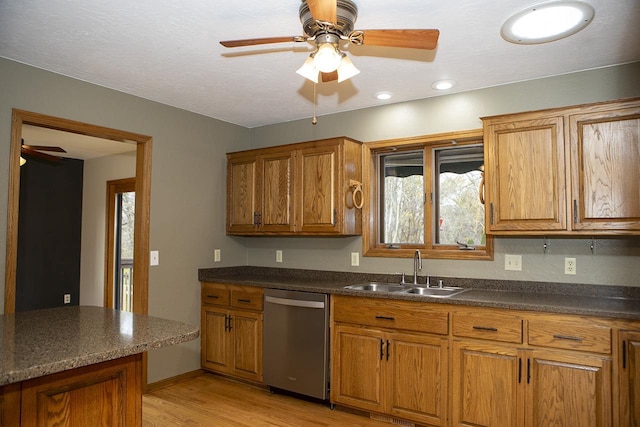 kitchen with stainless steel dishwasher, ceiling fan, light hardwood / wood-style floors, and sink