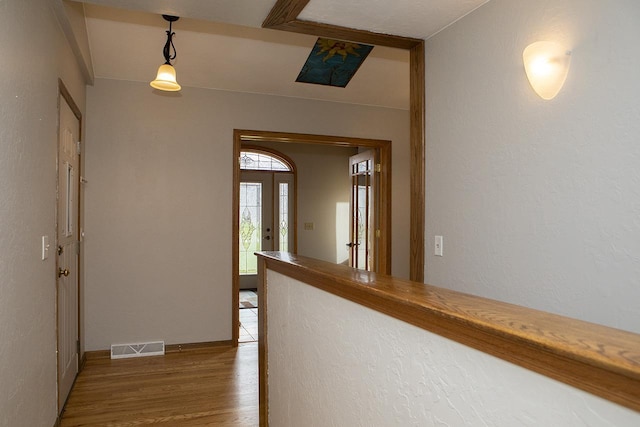 hallway with wood-type flooring