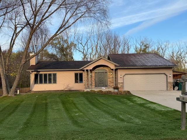 ranch-style house featuring a front lawn and a garage