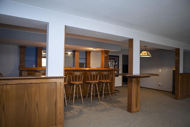 bar featuring dark carpet and hanging light fixtures