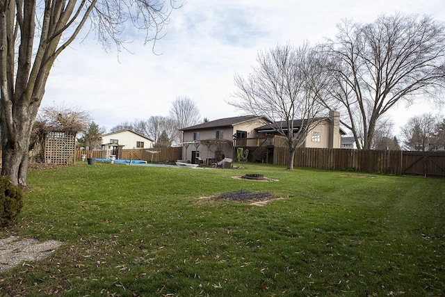 view of yard with a swimming pool side deck