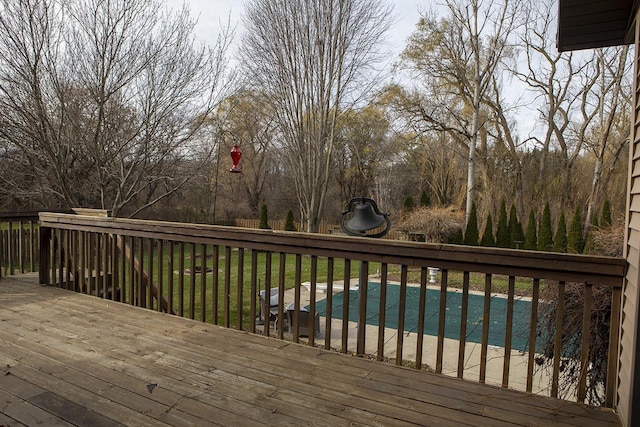 deck featuring a covered pool