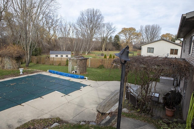 view of pool featuring a yard and a patio