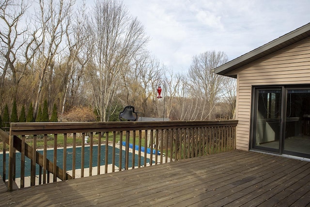 wooden deck with a covered pool