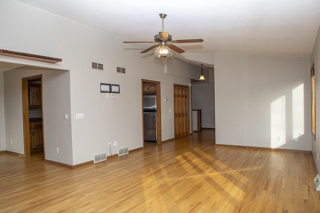 unfurnished living room featuring light hardwood / wood-style floors, ceiling fan, and lofted ceiling