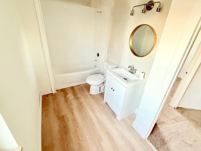 full bathroom featuring tiled shower / bath, vanity, toilet, and hardwood / wood-style flooring