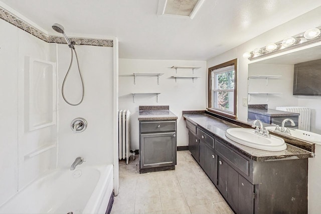 bathroom with radiator heating unit, vanity, tile patterned floors, and shower / bathing tub combination