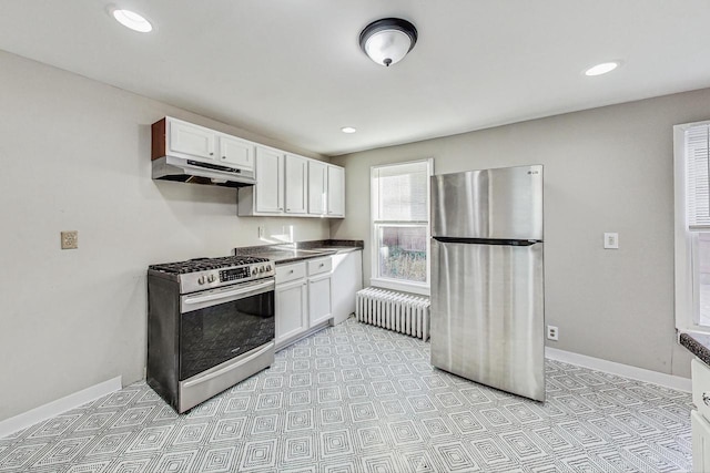 kitchen with white cabinets, radiator heating unit, and stainless steel appliances