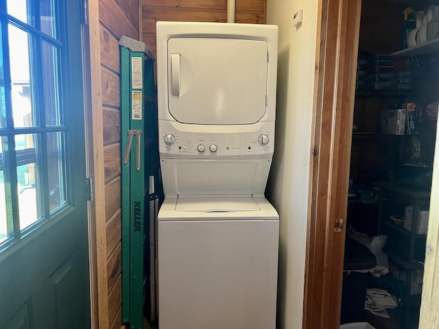 laundry room with stacked washer / drying machine