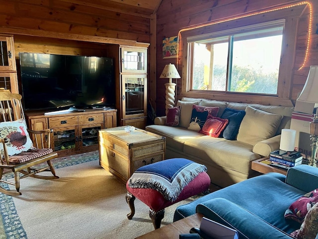 living room with carpet flooring, lofted ceiling, and wooden walls