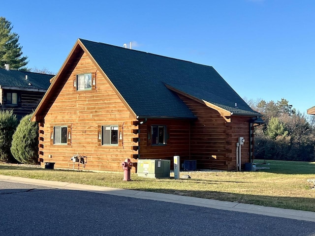 view of side of property with a lawn and central air condition unit