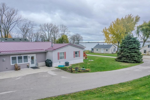 back of house with a yard and a patio