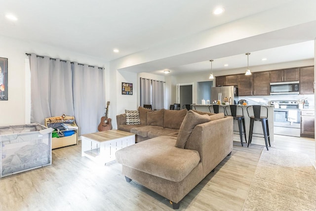 living room with light hardwood / wood-style flooring