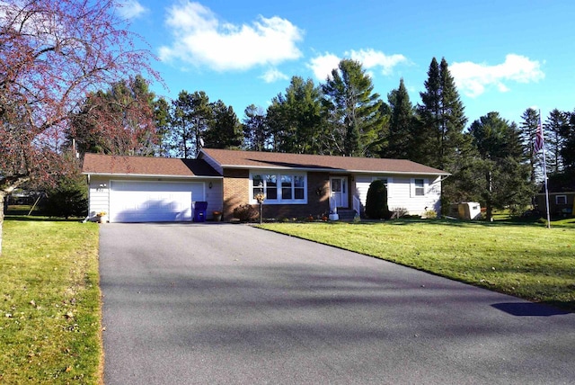 ranch-style house with a garage and a front lawn