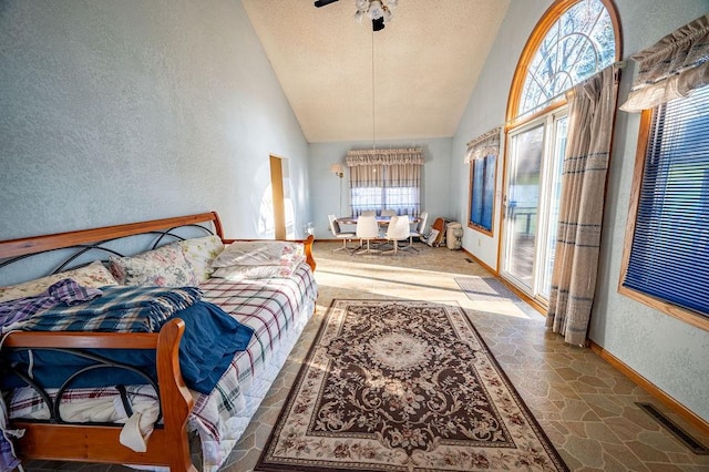 interior space featuring a textured ceiling, high vaulted ceiling, and ceiling fan