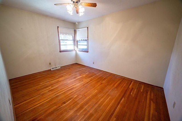 empty room featuring hardwood / wood-style flooring and ceiling fan