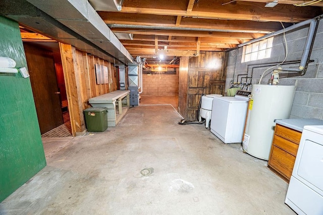 basement featuring heating unit, independent washer and dryer, and gas water heater