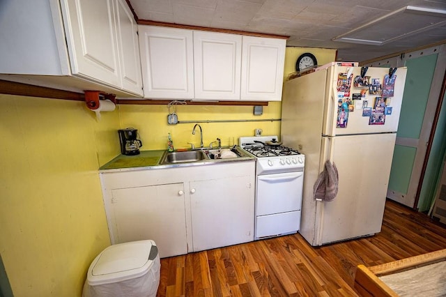 kitchen featuring white cabinets, white appliances, sink, and hardwood / wood-style flooring