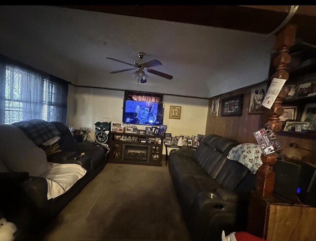 carpeted living area featuring a ceiling fan
