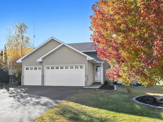 view of front of home featuring a garage and a front lawn