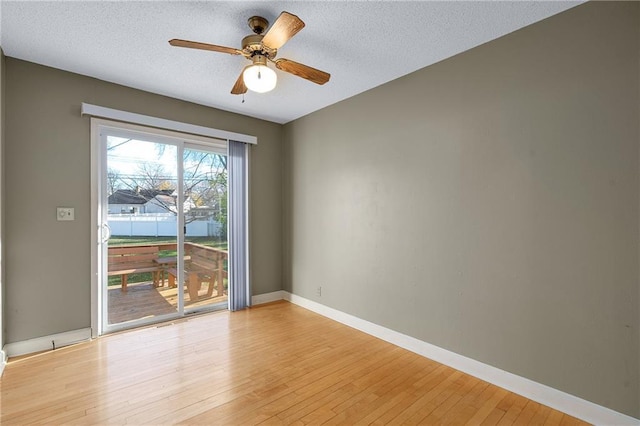 spare room with ceiling fan, a textured ceiling, and light hardwood / wood-style floors