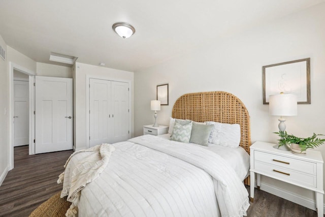 bedroom featuring dark wood-type flooring and a closet