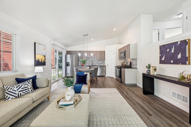 living room featuring dark wood-type flooring and lofted ceiling